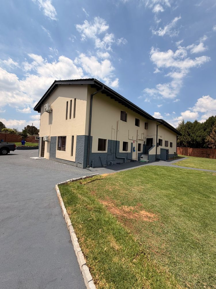 Two-storey guest house building beside the lawn