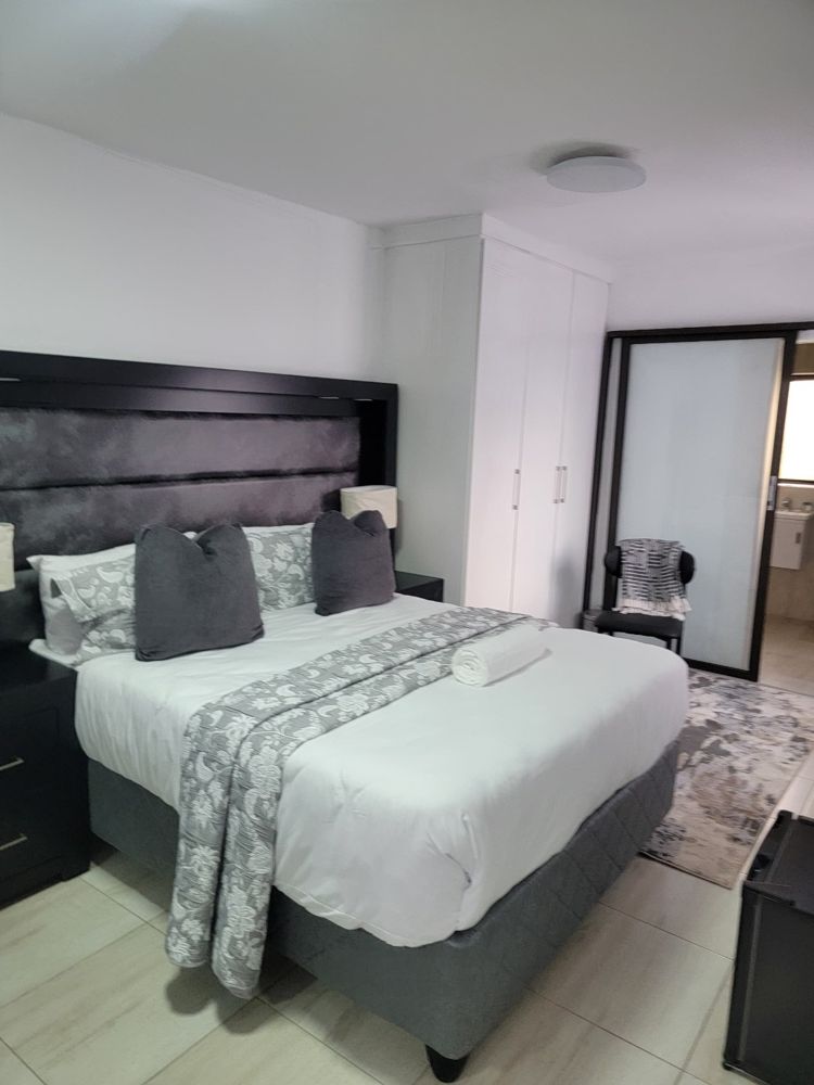 Outside Room bedroom with double bed, grey headboard and built-in wardrobe
