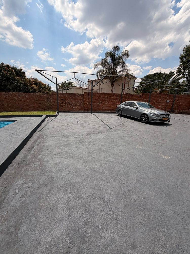 Secure paved parking area inside the walled property
