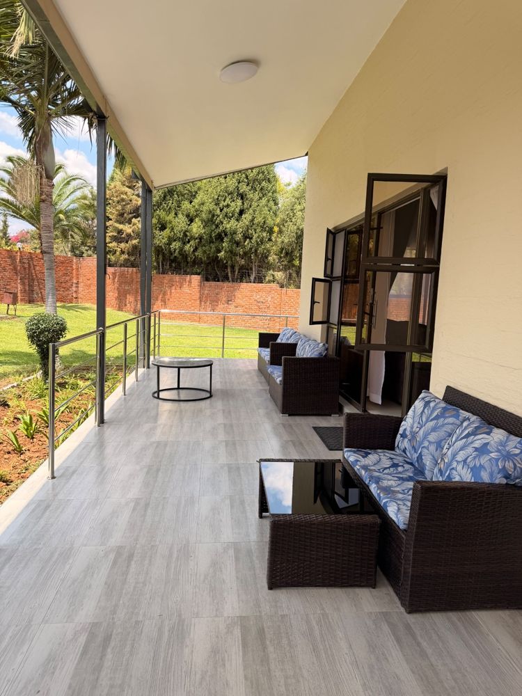 Covered veranda with wicker sofas overlooking the garden